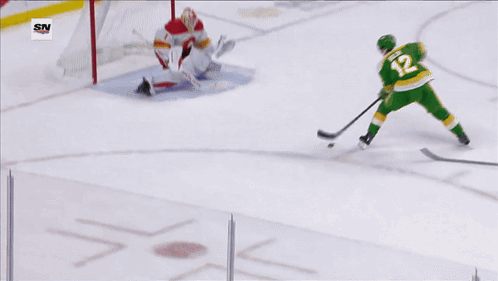 A Hockey Game Is Being Played In Front Of A Us Bank Banner GIF