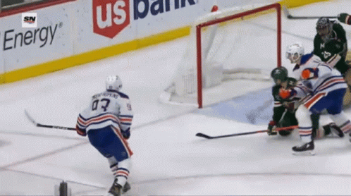 A Hockey Game Is Being Played In Front Of A Us Bank Banner GIF