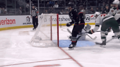 A Hockey Game Is Being Played In Front Of A Verizon Advertisement GIF