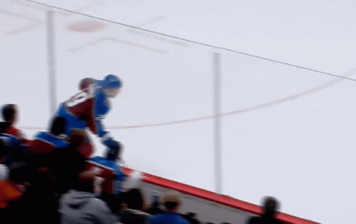 A Hockey Game Is Being Played In Front Of A Verizon Banner GIF