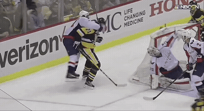 A Hockey Game Is Being Played In Front Of A Verizon Banner GIF