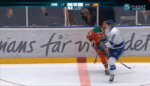 A Hockey Game Is Being Played In Front Of A Wall That Says Hans Far In Det GIF