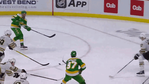 A Hockey Game Is Being Played In Front Of A West Bend Ad GIF