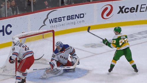 A Hockey Game Is Being Played In Front Of A West Bend Advertisement GIF