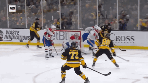 A Hockey Game Is Being Played In Front Of An Ad For Cross Insurance GIF