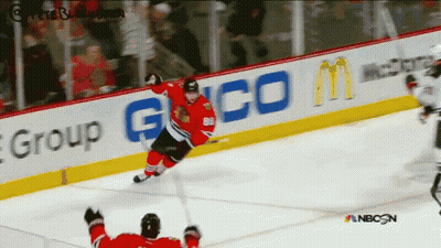 A Hockey Game Is Being Played In Front Of An Ad For Geico GIF