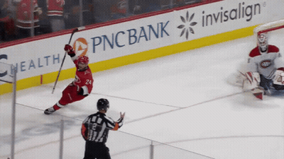 A Hockey Game Is Being Played In Front Of An Ad For Pnc Bank GIF