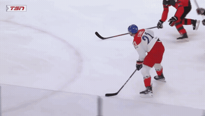 A Hockey Game Is Being Played In Front Of An Ad For Tim Hortons GIF