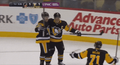 A Hockey Game Is Being Played In Front Of An Advance Auto Parts Ad GIF