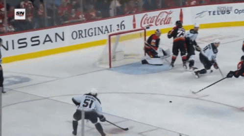A Hockey Game Is Being Played In Front Of An Advertisement For Coca-Cola GIF
