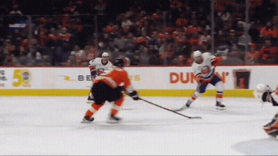 A Hockey Game Is Being Played In Front Of An Advertisement For Dunkin ' GIF