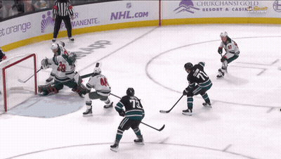 A Hockey Game Is Being Played In Front Of An Nhl.com Ad GIF