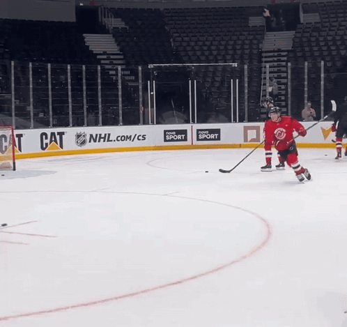 A Hockey Game Is Being Played In Front Of An Nhl.com/cs Banner GIF