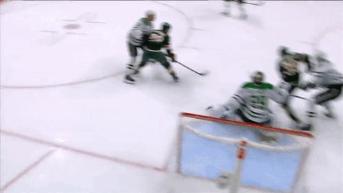 A Hockey Game Is Being Played On A Ice Rink And The Goalie Is Wearing A Number 23 Jersey GIF