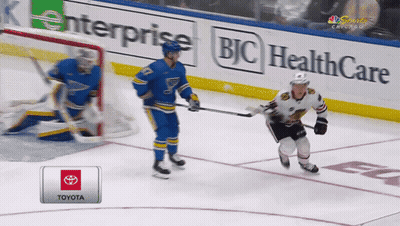A Hockey Game Is Being Played On A Toyota Sponsored Rink GIF