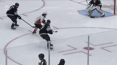 A Hockey Game Is Being Played On The Ice And The Goalie Is Wearing Bauer Gloves GIF