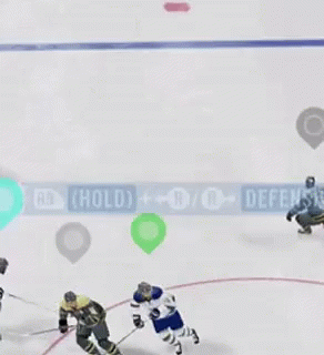 A Hockey Game Is Being Played On The Ice And The Players Are Playing Defense GIF