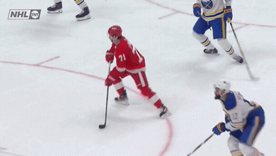 A Hockey Game Is Being Played With A Nhl Logo On The Ice GIF