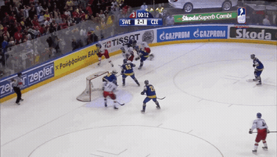 A Hockey Game Is Being Played With Ads For Skoda And Tissot On The Ice GIF