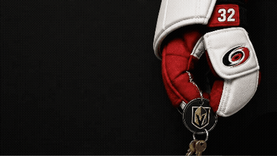 A Hockey Glove With The Number 32 On It Is Hanging On A Key Chain GIF