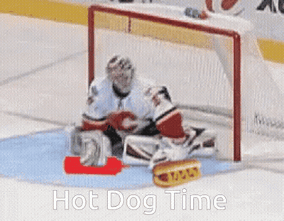 A Hockey Goalie Is Laying On The Ice With A Hot Dog In Front Of Him And The Words Hot Dog Time Below Him GIF