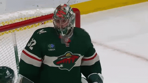 A Hockey Goalie Wearing A Jersey With The Number 32 On It GIF