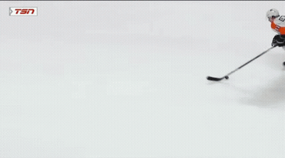 A Hockey Goalie With The Number 31 On His Jersey Makes A Save GIF