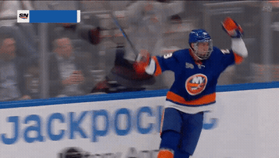 A Hockey Player Celebrates A Goal In Front Of A Banner That Says Jackpot GIF