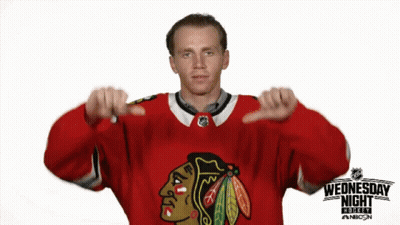 A Hockey Player Giving A Thumbs Down Sign In Front Of A Sign That Says Wednesday Night GIF