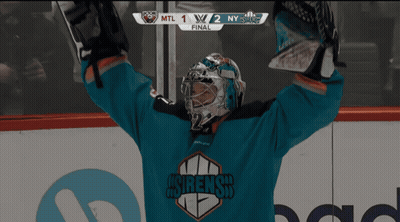 A Hockey Player Holds His Arms In The Air In Front Of A Scoreboard That Says Mtl 1/2 Ny On It GIF