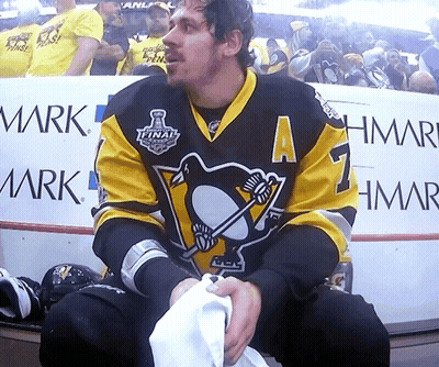 A Hockey Player In A Black And Yellow Jersey With The Number 7 On It GIF