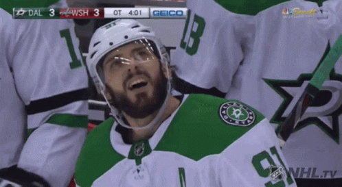 A Hockey Player In A Green And White Jersey With The Number 9 On It GIF