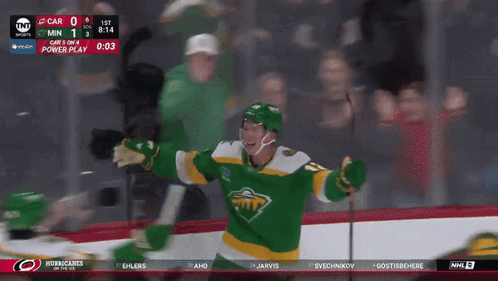 A Hockey Player In A Green And Yellow Jersey Celebrates GIF