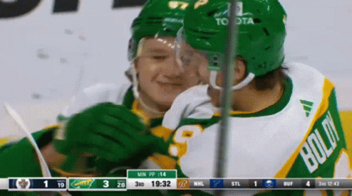 A Hockey Player In A Green Jersey With Bold On It GIF