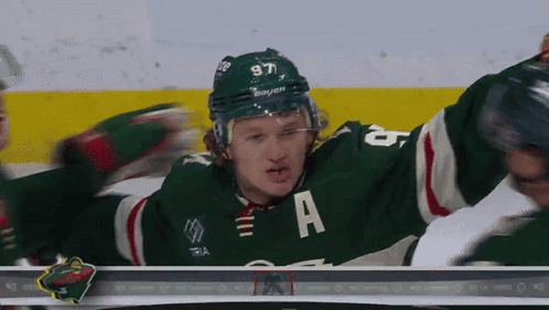 A Hockey Player In A Green Jersey With The Letter A On It GIF