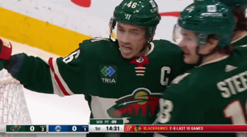 A Hockey Player In A Green Jersey With The Letter C On It GIF