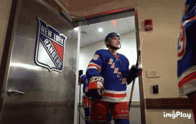 A Hockey Player In A New York Rangers Uniform Walks Out Of A Doorway GIF