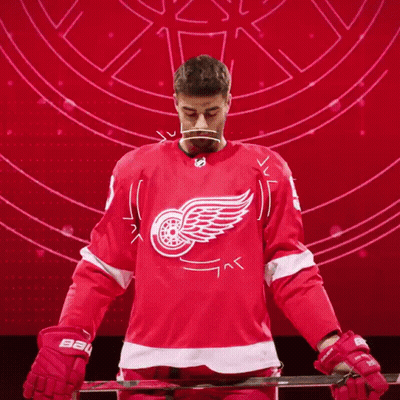 A Hockey Player In A Red Jersey And Gloves With The Letter B On The Gloves GIF