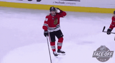 A Hockey Player In A Red Jersey With The Number 38 On It GIF