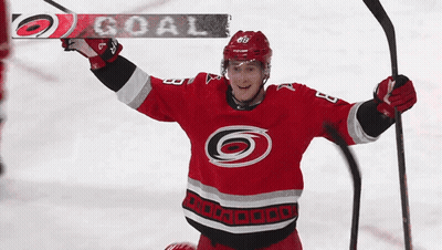 A Hockey Player In A Red Jersey With The Number 68 On It GIF