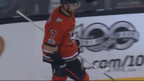 A Hockey Player In A Red Jersey With The Number 7 On It GIF