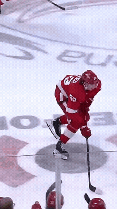 A Hockey Player In A Red Uniform With The Number 52 On His Back GIF