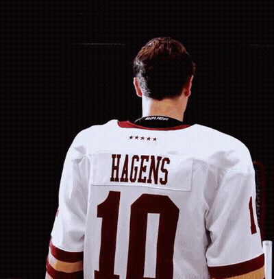 a hockey player in a white jersey with the number 10 on it