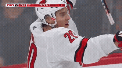 A Hockey Player In A White Jersey With The Number 20 On It GIF