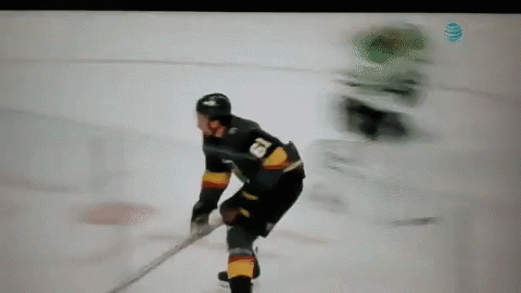 A Hockey Player Is Holding A Stick On The Ice GIF