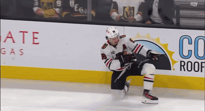 A Hockey Player Is Kneeling On The Ice In Front Of An Advertisement For Co Roof Gas GIF