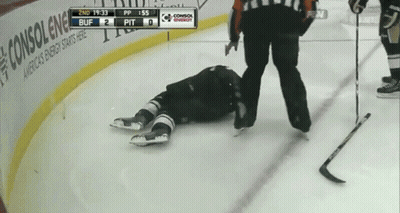 A Hockey Player Is Laying On The Ice With The Scoreboard Showing 2Nd 19:33 Buff 2 Pit GIF