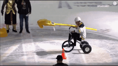 A Hockey Player Is Riding A Bike On The Ice With The Sportsnet Logo In The Background GIF