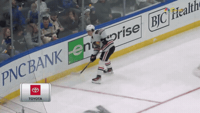 A Hockey Player Is Skating On The Ice In Front Of A Pnc Bank Banner GIF