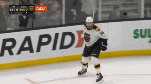 A Hockey Player Is Skating On The Ice In Front Of An Ad For Futbo GIF